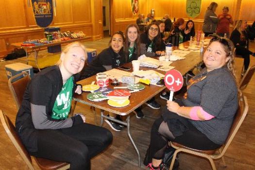 BBD phlebotomist enjoying a snack at a long table.