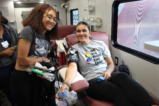 Blood donor in donation chair and BBD phlebotomist at the Goldey-Beacom College Blood Drive .