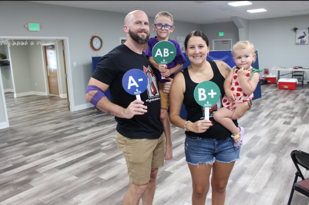 Jason and his fiancée, Shane Simmons, with family at a blood drive.